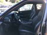 the interior of a car with the door open and the steering wheel down