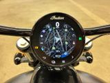 a clock on the handlebar of a motorcycle