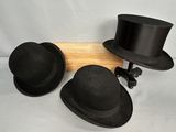 three hats that are sitting on top of a wooden pole