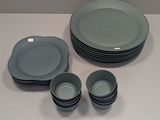 a lot of plates and cups sitting on a table