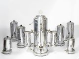 a lot of silver items that are on a white surface