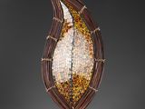 a close up of a sculpture of a leaf on a stand