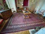a living room with a rug and a table in it