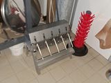 a picture of a kitchen with a red brush on the floor