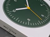 a white box with a green and yellow clock on it