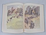 an open book with a picture of a village on it