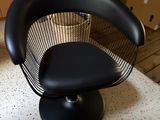 a black chair that is sitting on a table