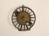 a small metal object that is hanging on the wall
