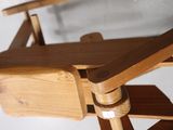a wooden chair that has a wooden seat on top of it