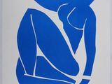 an image of a blue and white painting of a woman sitting on the ground