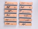 several small wooden pegs with writing on them sitting on a table