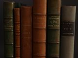 a lot of books that are sitting on a shelf