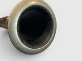 an image of a black and gold pipe on a white surface