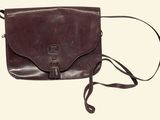 brown leather cross body bag with shoulder strap on white background