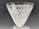 a clear glass vase on a clear pedestal