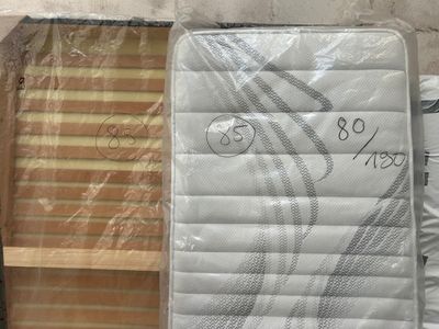 a mattress that is sitting on the floor next to other mattresses