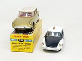 a toy car and a box of toys on a white surface