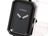 a black watch with a black face on a clear watch band