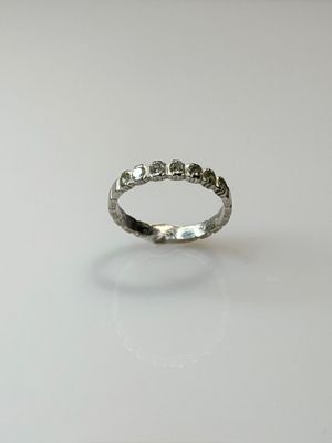 a close up of a silver ring on a white surface