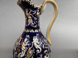 a blue and gold vase with a dragon design on it