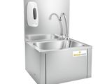 a close up of a stainless steel sink with a faucet and soap dispenser