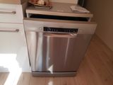 a dishwasher in the corner of a small kitchen
