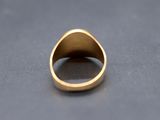 a close up of a gold ring on a gray surface