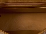the inside of a brown purse with a zipper on it