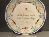 a plate with a quote on it sitting on a table