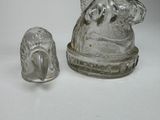 a glass figurine and a glass salt shaker sitting on a table