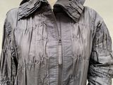 an image of a mannequin wearing a gray jacket