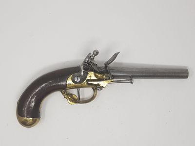 an old gun that is on display on a white surface