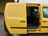 a yellow van with its doors open in a parking lot