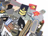 a lot of different military patches on a white surface