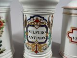 three ceramic containers with decorative designs are lined up on a table