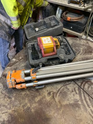 a man that is standing next to some tools on a table