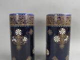 pair of blue and gold vases on a white background