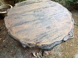 a wooden table that is sitting in the middle of the yard