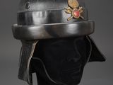 a silver helmet with a gold eagle emblem on it