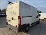a white van that is parked in the dirt