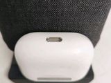 a white apple airpods sitting on top of a black bag