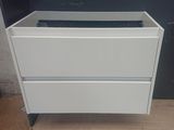 a white cabinet with two drawers on it