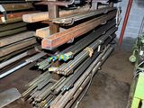 many different types of steel bars stacked up in a room