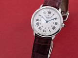 an image of a white wrist watch with roman numerals on a brown leather strap
