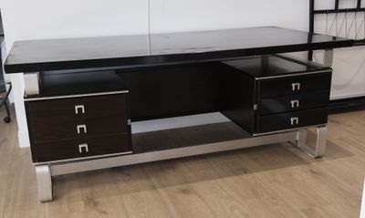 a desk with two drawers and a shelf on the wall