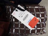 a bag with a tag on it sitting on the floor