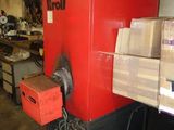 une grosse machine rouge qui se trouve dans un entrepôt