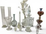 many different glass vases and vases on the table