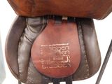 a close up of a saddle with a leather cover on it