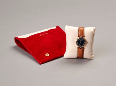 a red and white pillow with a watch on it